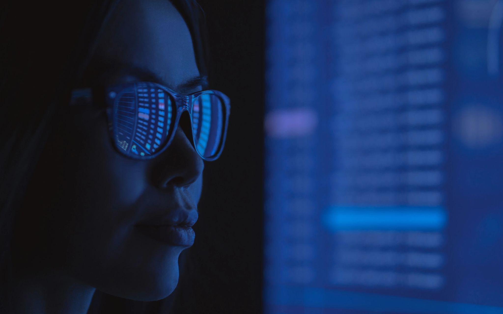 Woman in glasses viewing a computer screen